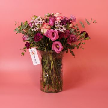 Vibrant rose and mixed floral bouquet in a glass vase, Flowers Shop Amman Jordan.