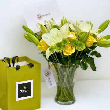 Amman Bliss bouquet with white lilies, yellow roses, green chrysanthemums, and Patchi Chocolate, delivered in Amman, Jordan.