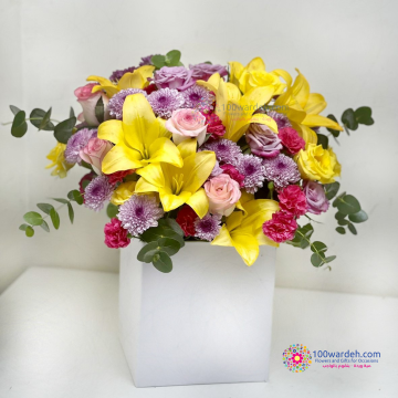 Yellow Lilies and pink flowers in a box